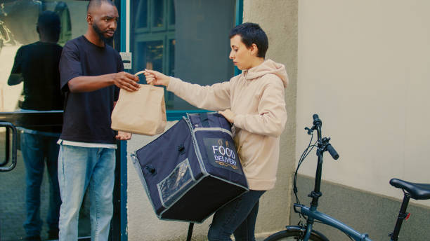 istock Confused courier delivering wrong fastfood order to client 1436601500