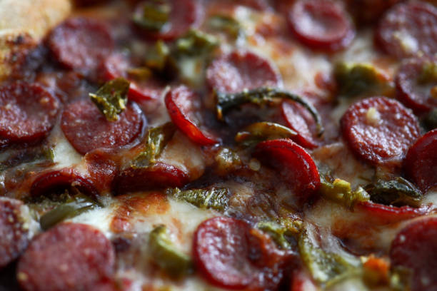 Fresh baked pizza with crusty cheese and hot tasty pepperoni ready to eat