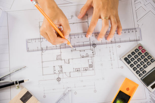istock Architect drawing with ruler on house plan blueprint paper for repair tools on table 1436603941