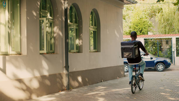 istock Deliveryman arriving at client front door to give takeaway meal 1436604369