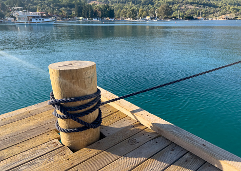 a bollard made of wood and tied with rope