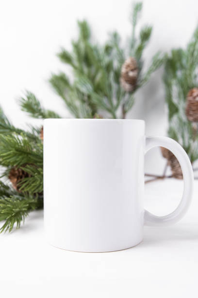 istock Mockup of a white ceramic cup with a Christmas tree, front view. Mug for logo, text. 1436606058