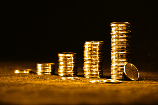 Golden coins isolated on black background