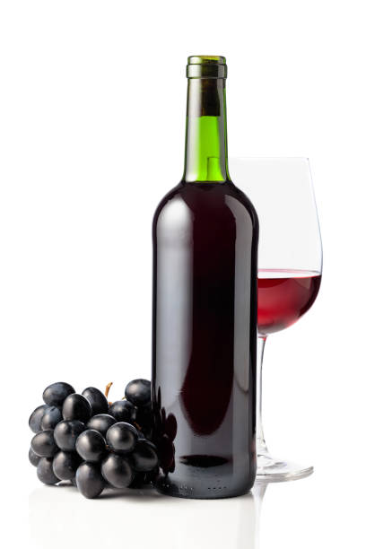 Red wine and blue grapes are isolated on white. stock photo