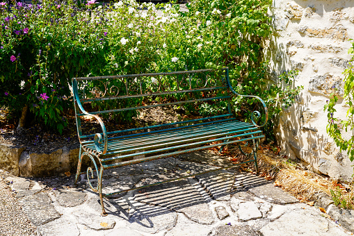 wooden steel bench green iron and wood in summer street in ancient medieval village