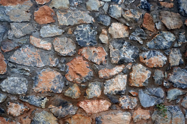 istock Texture - a wall made of natural raw stone. Wet after the rain 1436616630