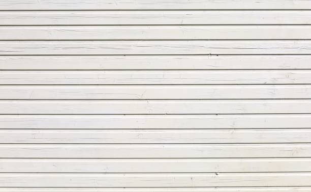 istock White painted wood paneling with horizontal strips under the sunlight. 1436619428