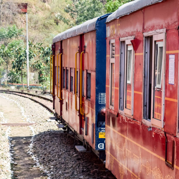 istock Toy Train moving on mountain slopes, beautiful view, one side mountain, one side valley moving on railway to the hill, among green natural forest. Toy train from Kalka to Shimla in India, Indian Train 1436620180