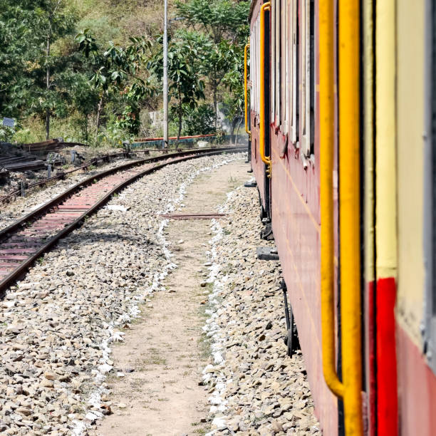 istock Toy Train moving on mountain slopes, beautiful view, one side mountain, one side valley moving on railway to the hill, among green natural forest. Toy train from Kalka to Shimla in India, Indian Train 1436620181