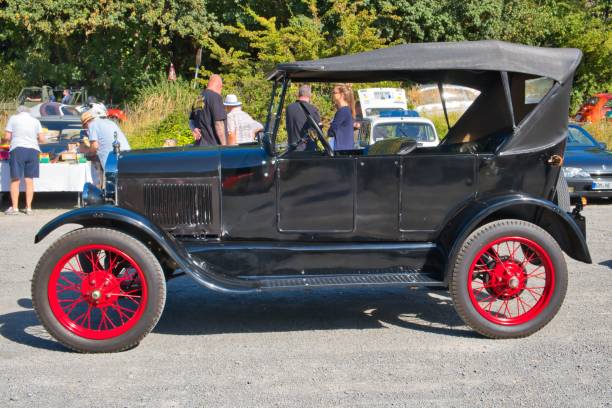 Black Ford Model T, classic ca Burscheid, Germany – August 21, 2022: Black Ford Model T, produced from 1908 - 1927 ,oldtimer, classic car, side view 1908 stock pictures, royalty-free photos & images