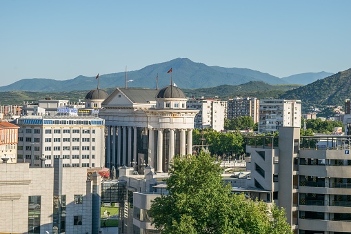 Skopje, Macedonia – July 14, 2022: An elevated landscape view of the city of Skopje, capital of North Macedonia. A mixture of architectural styles, Arabic, Neo-Classical, modern.