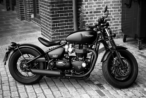Ipswich, United Kingdom – September 06, 2022: A grayscale shot of a parked Triumph Bonneville Bobber Motorcycle