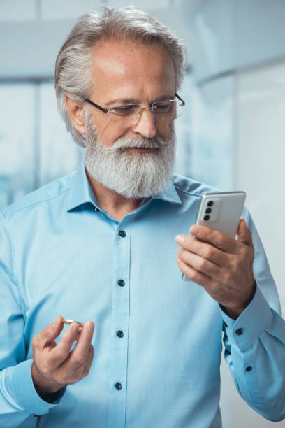 istock Senior businessman holding Bitcoin coin 1436626866