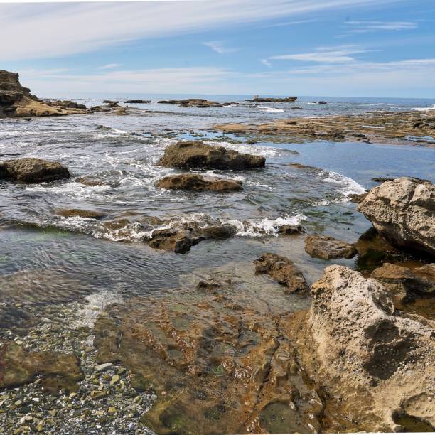 istock Watching the tide rush in over the jagged rocks on a spectacular sunny day. 1436628727