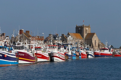 Barfleur, France – October 14, 2021: Colorful fishing ships in the Port Barfleur, Normandie on a bright day.