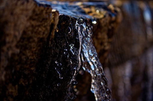 Closeup of a fountain water flowing down captured in Venstpills