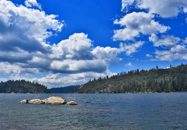 istock Scenic lake view with forest and vibrant blue sky 1436631753