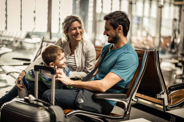 istock Happy family talking while waiting their transportation on a station. 1436632882
