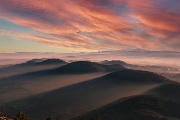 istock Beautiful scenery of hills under cloudy red sky at sunset 1436634314