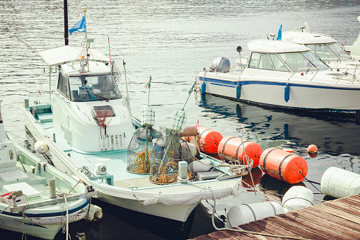 Top down drone shot of a number of fishing boats in a marina on the Washington Coast.