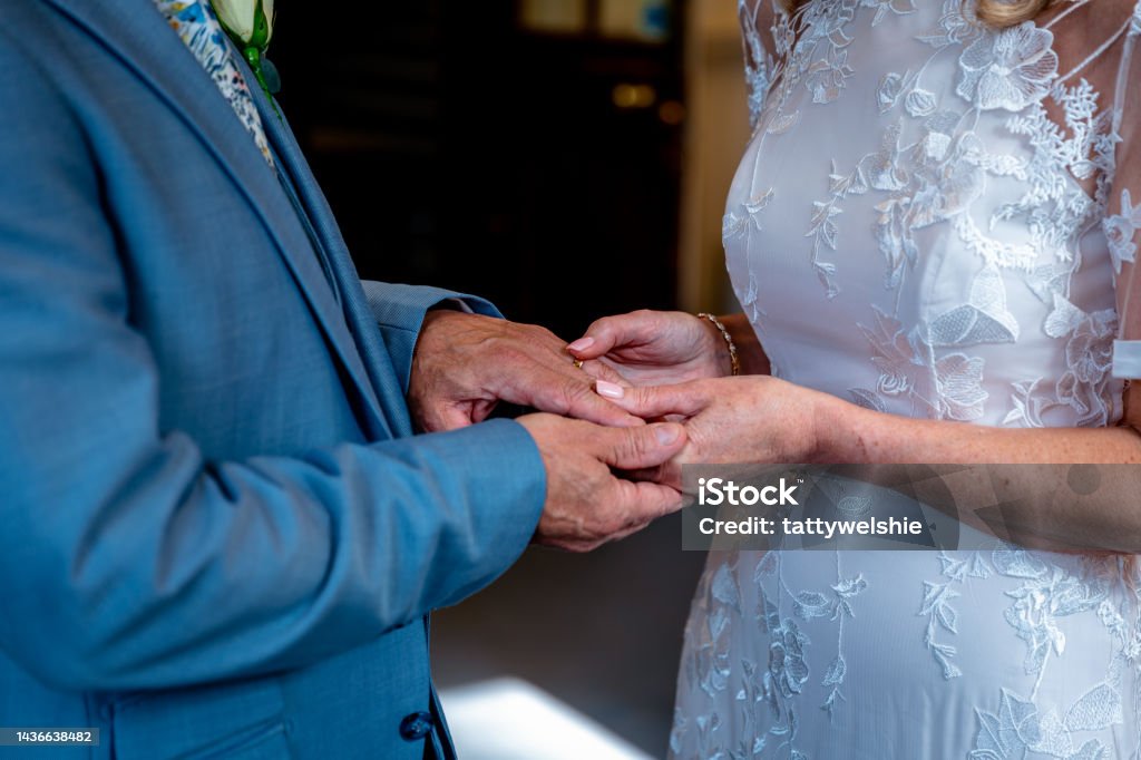 Bride and groom getting married Bride and groom getting married, holding hands at their wedding ceremony Adult Stock Photo