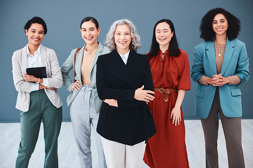 Leadership, teamwork and diversity with a woman CEO and team in studio on a gray background for growth or mission. Manager, collaboration and vision with a female group standing together for success