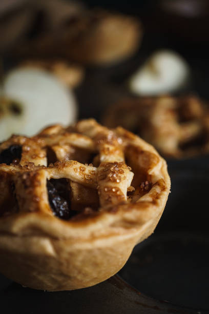 Mini Apple Pie Tarts in dark style food image. Fresh baked and home made food photo.