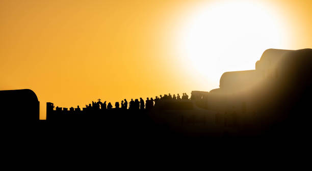 istock People in silhouette at sunset on a Greek island 1436642469