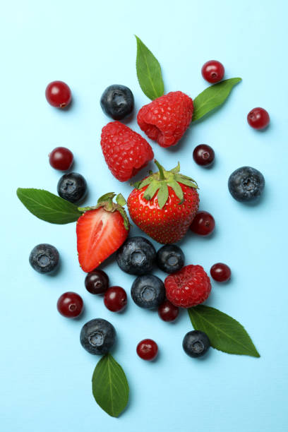 istock Delicious fresh berry mix on blue background 1436642903