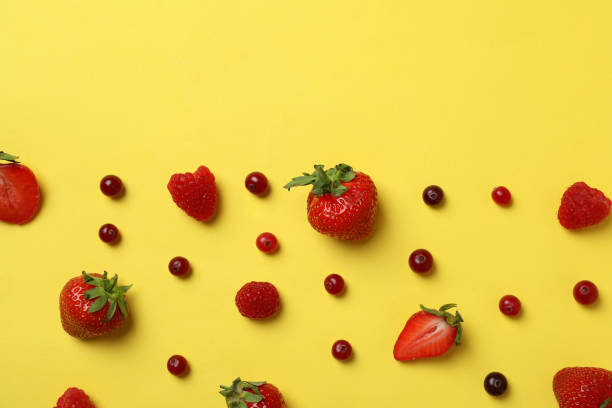 istock Delicious fresh berry mix on yellow background 1436642918