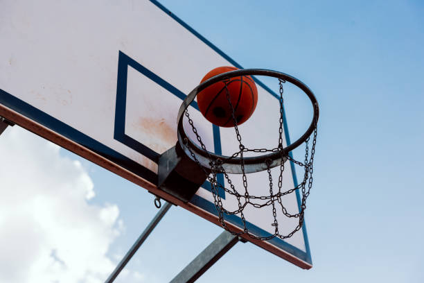 istock Scoring winning points at basketball game ball flies through basket 1436643206