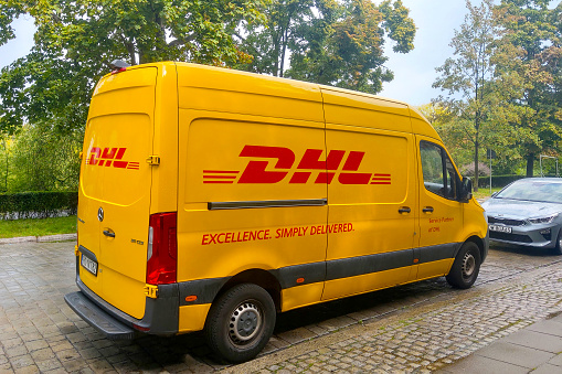Lisbon, Portugal – October 20, 2022: A yellow DHL delivery truck in the street