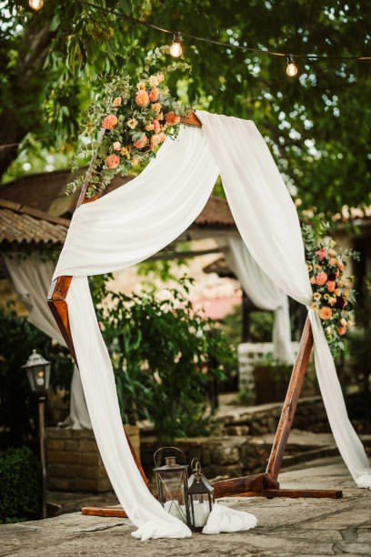 istock Beautiful wedding arch decorated with fresh flowers 1436645543