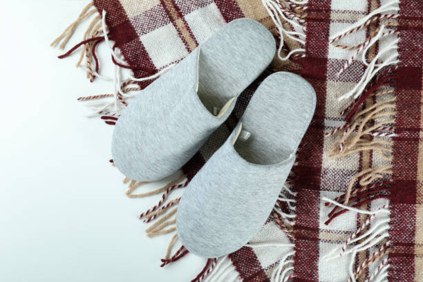 istock Pair of house slippers and plaid on white background 1436651279