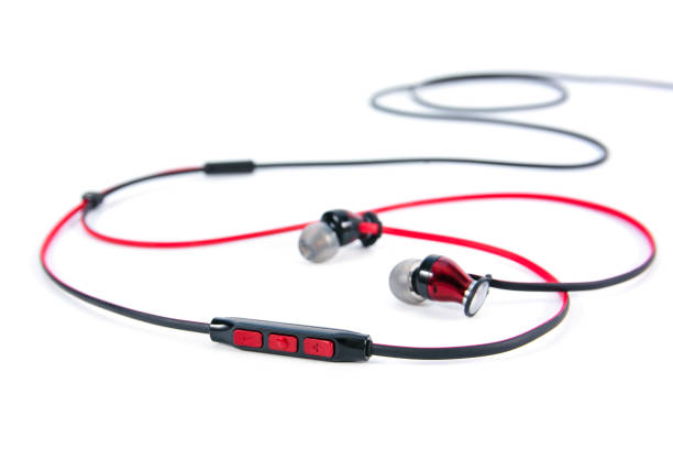 istock In ear headphones speaker button control isolated on white background. Closeup red and black wire in-ear headphones speaker button volume control isolated. 1436651692