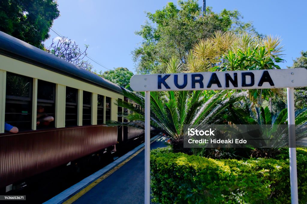 A train and gate of Kuranda raiway station, Queensland, Australia Overhead Cable Car Stock Photo