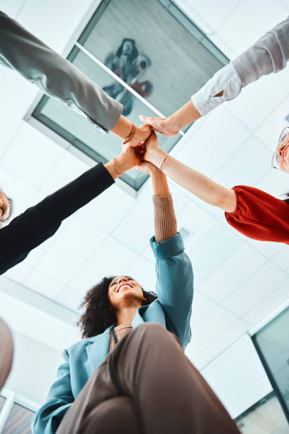 istock Hands, team and high five in support for business collaboration, unity and trust below at the office. Hand of creative people in teamwork agreement for company success, partnership and goals at work 1436653985