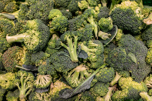 Broccoli in a pile on the supermarket shelf