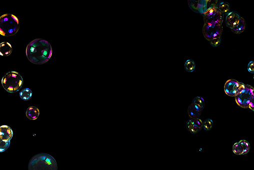 Soap bubbles isolated on a black background. Copy space.