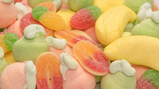 Mix of jelly colorful candys and marshmallows as a background.