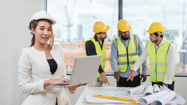 istock Portrait of engineers facing the camera as they wrap up a group discussion for an architectural project. 1436661311