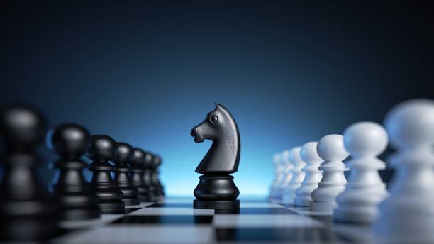 istock 3d rendering, chess game knight piece stands in the middle of the chessboard between two rows of pawns. Black horse over the blue background 1436663455