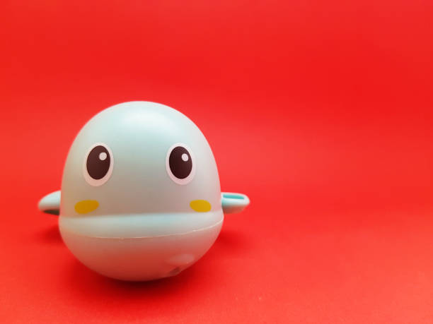 istock Front view of a children's toy with a light blue turtle character on red background 1436664222