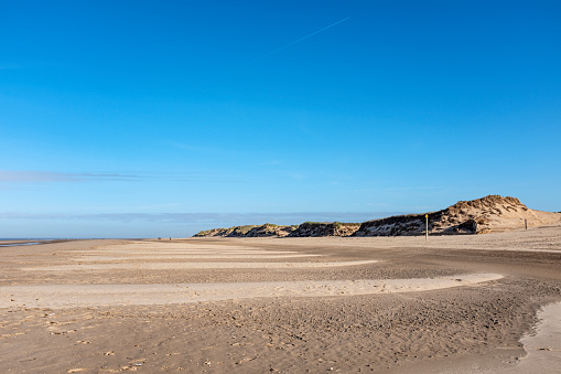 Much loved beach in UK with sand dunes. Figures in distance. Formby near Southport