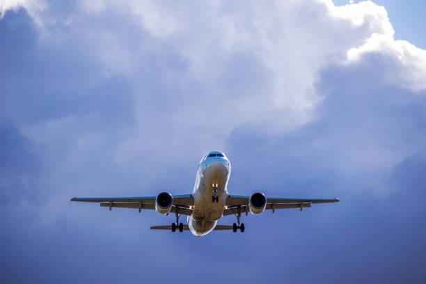 istock Airplane flying in the blue sky with clouds 1436669581