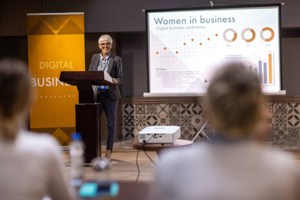 istock Woman speaking at a business conference 1436669933
