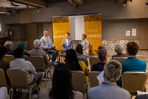 Business people on panel discussion in convention center