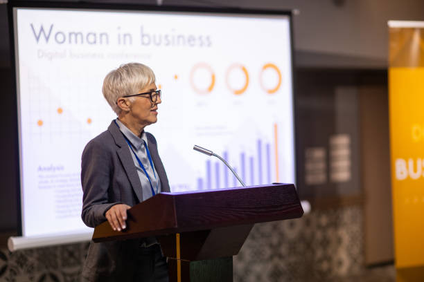 istock Woman speaking at a business conference 1436670058