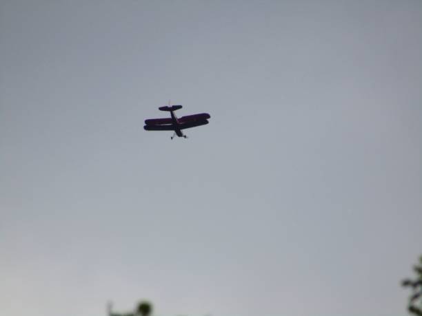 istock Low angle of biplane flying high in the sky 1436672168