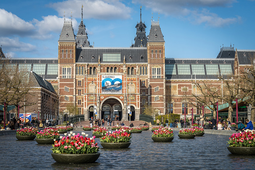 – May 01, 2021: A closeup of the Rijksmuseum in Amsterdam with tulips in summer
